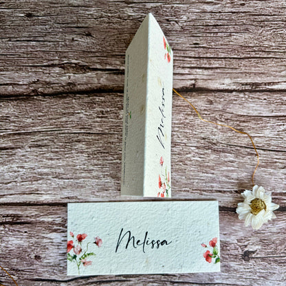 plantable wedding place cards with sweet pea design on a wooden surface