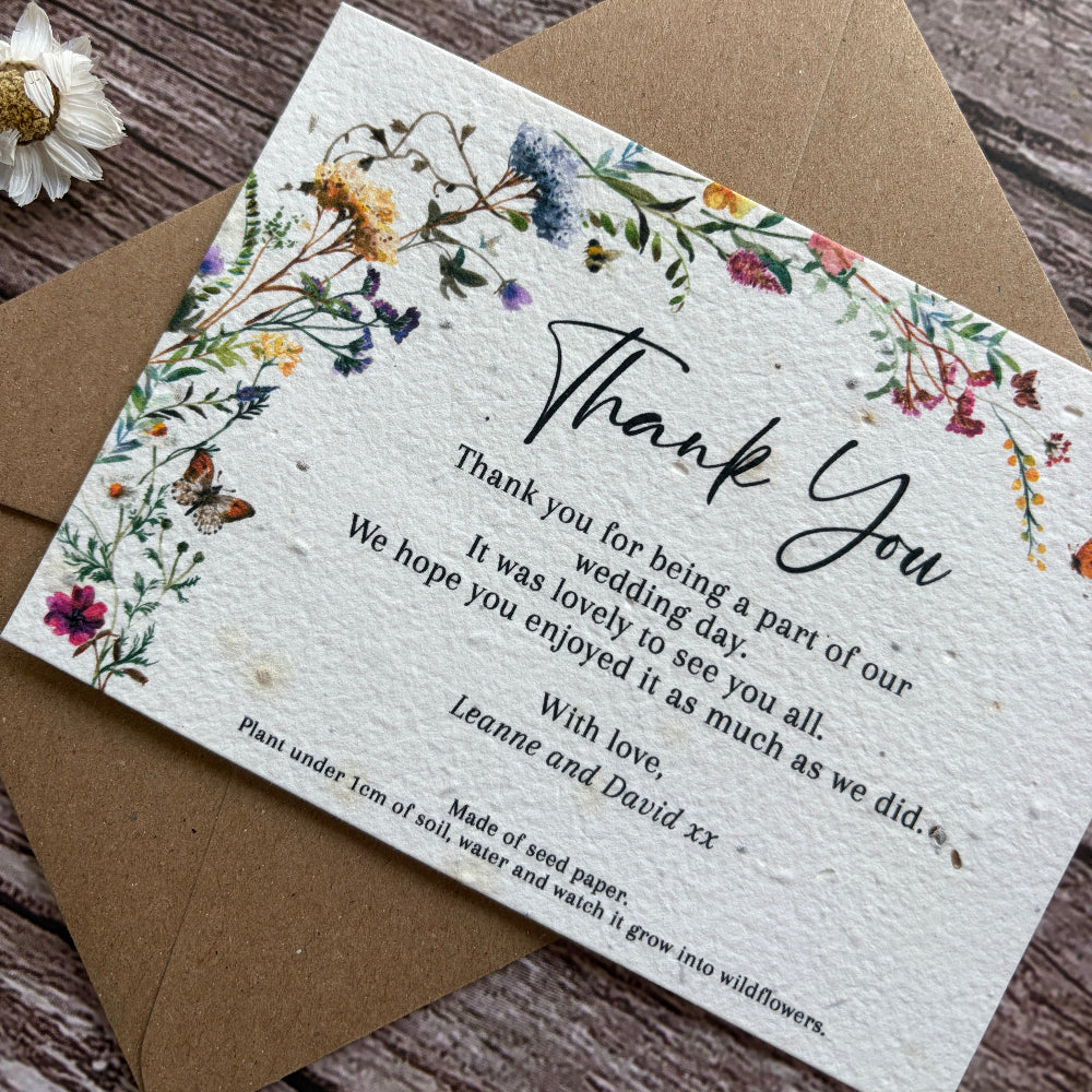 Thank you card with floral design on a wooden surface