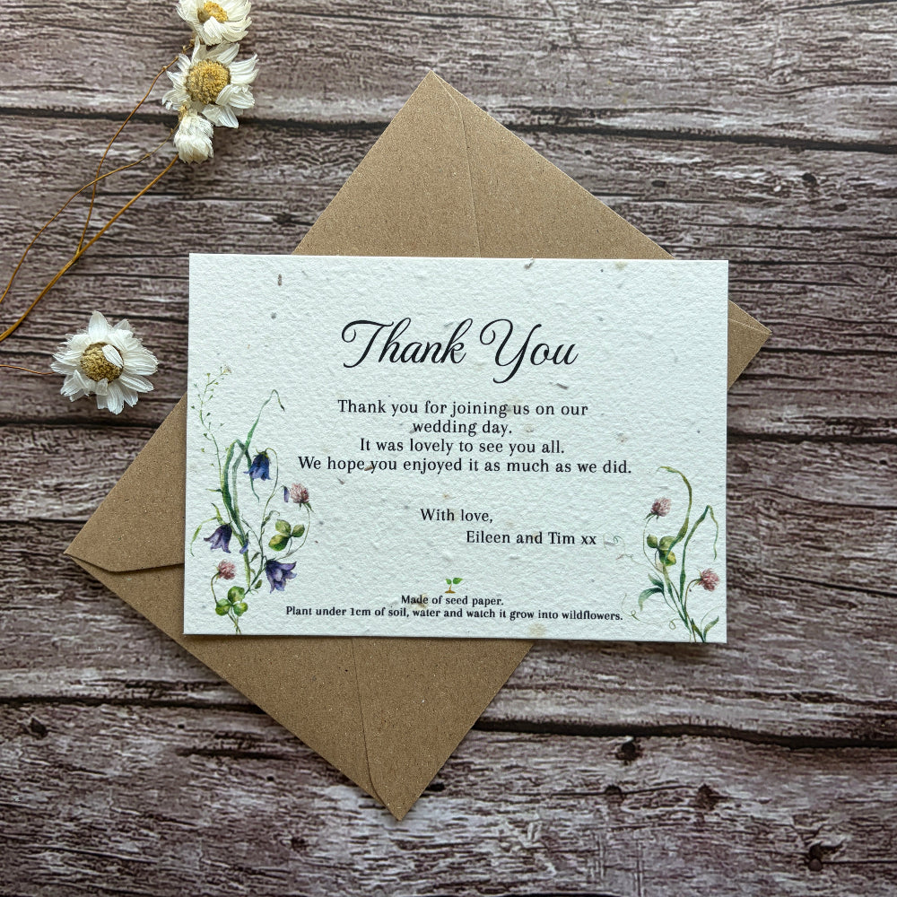 plantable wedding thank you card with clovers and bluebells on a wooden background