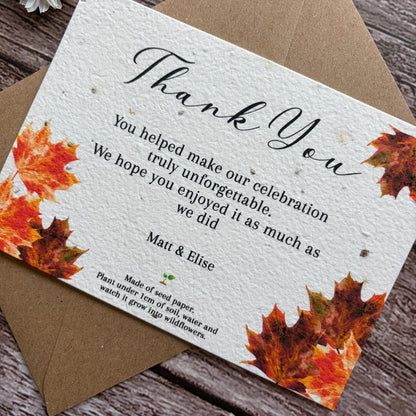 Plantable wedding Thank you card with autumn leaves design on a wooden surface