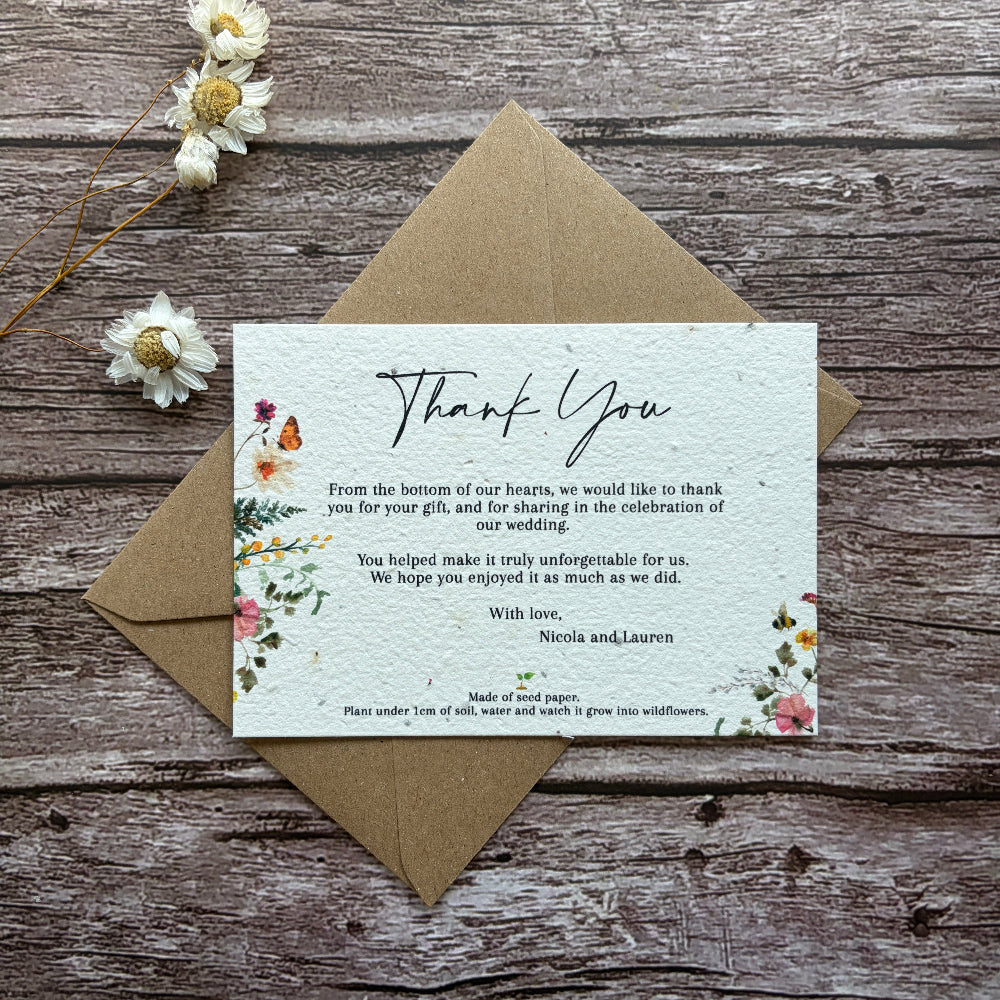 Plantable wedding thank you card with floral design and text on a wooden surface