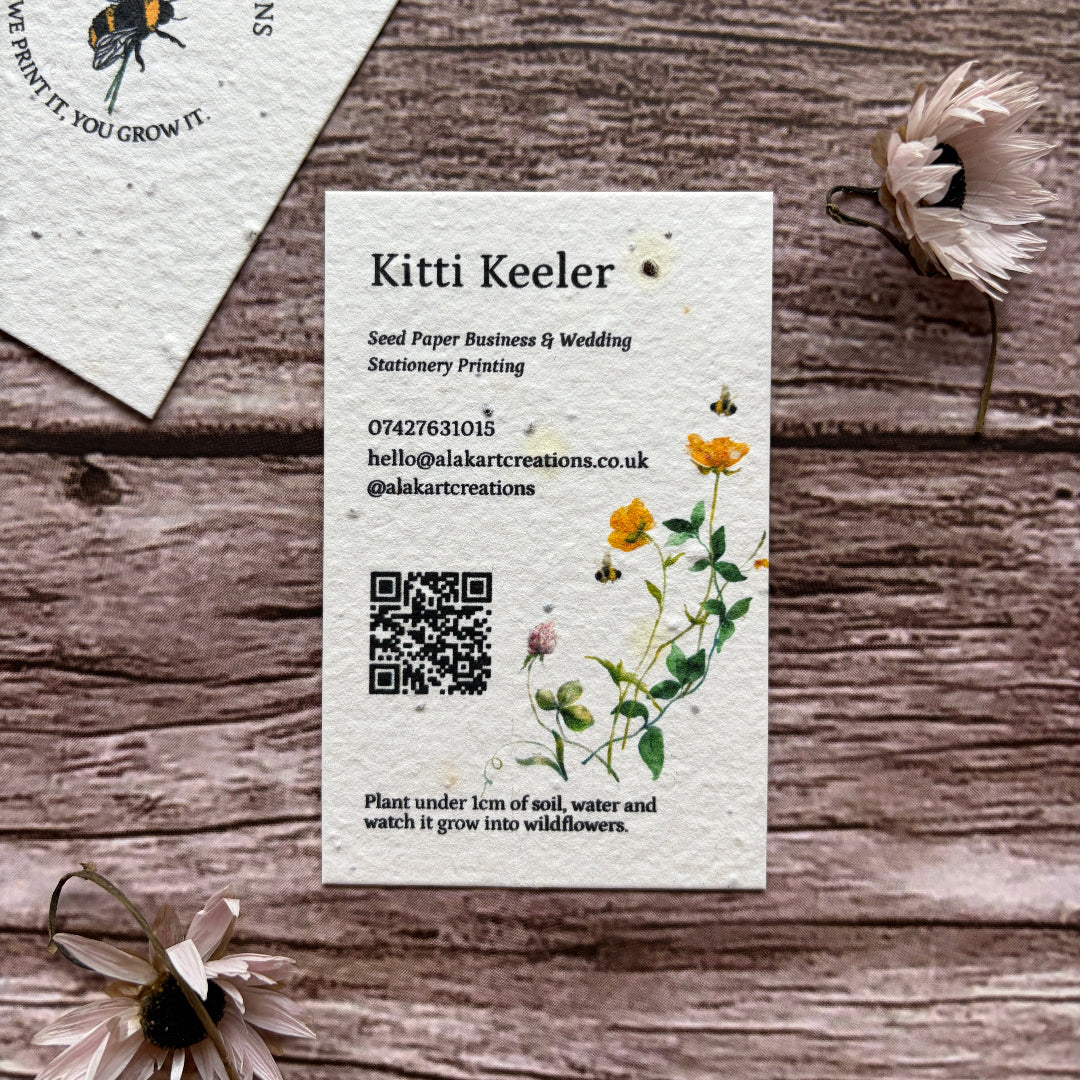 Business card with floral design on a wooden surface portrait style