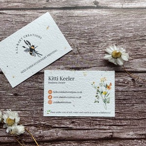 pre-designed plantable business cards with orange logo and wildflowers, showcasing eco-friendly floral design and sustainable branding, alakartcreations