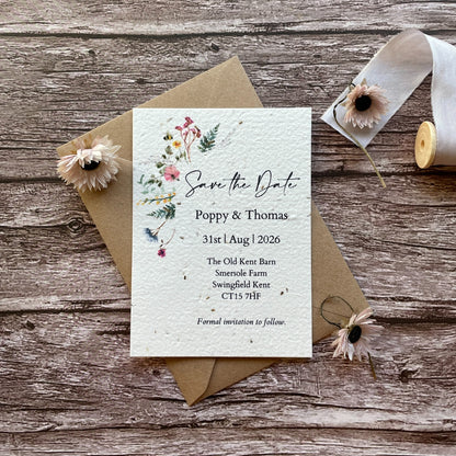 personalised plantable save the date card with wildflower meadow design and kraft envelope, flat lay style, alakartcreations