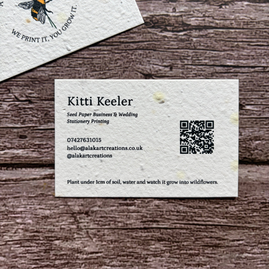 Seed paper business card with QR code on a wooden surface