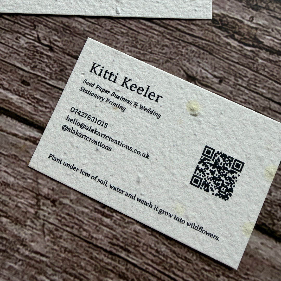 seed paper business cards with qr code on a wooden background