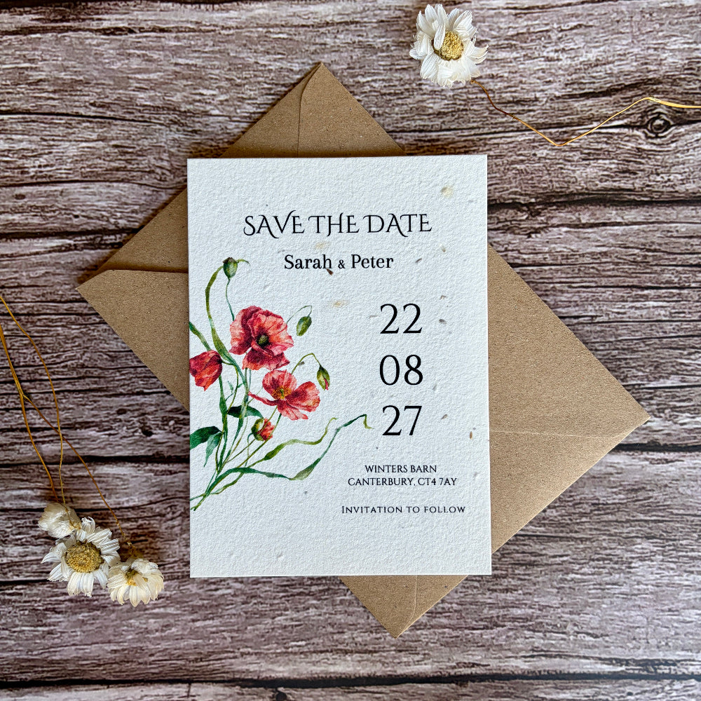Plantable save the date card with poppies design on a wooden surface