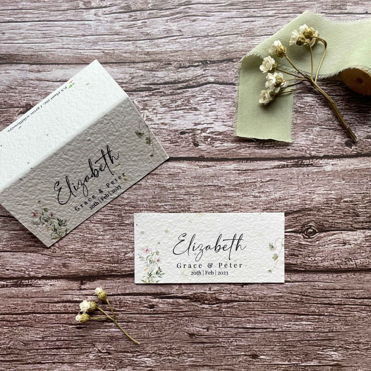 name cards for wedding guest with pink wildflowers made of plantable paper