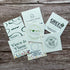 Collection of branded square plantable seeded business cards on a wooden surface
