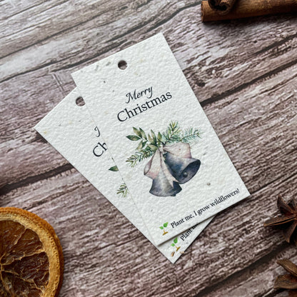 Front view of a single vintage bells plantable Christmas gift tag, angled to the left.