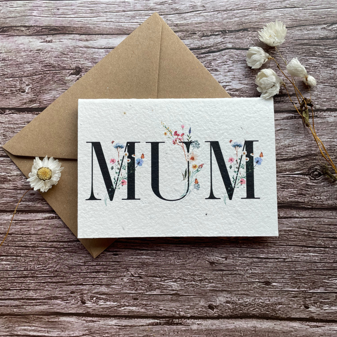 personalised plantable mother's day card with the word "mum" entwined with wildflowers, handmade from seed paper. front view.
