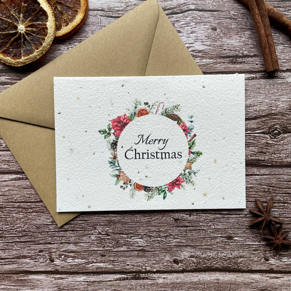 plantable Christmas card with wreath design on a wooden background