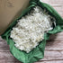 Right angled view of 1kg Plantable Shredded Box Filler showcasing the shredded plantable material.