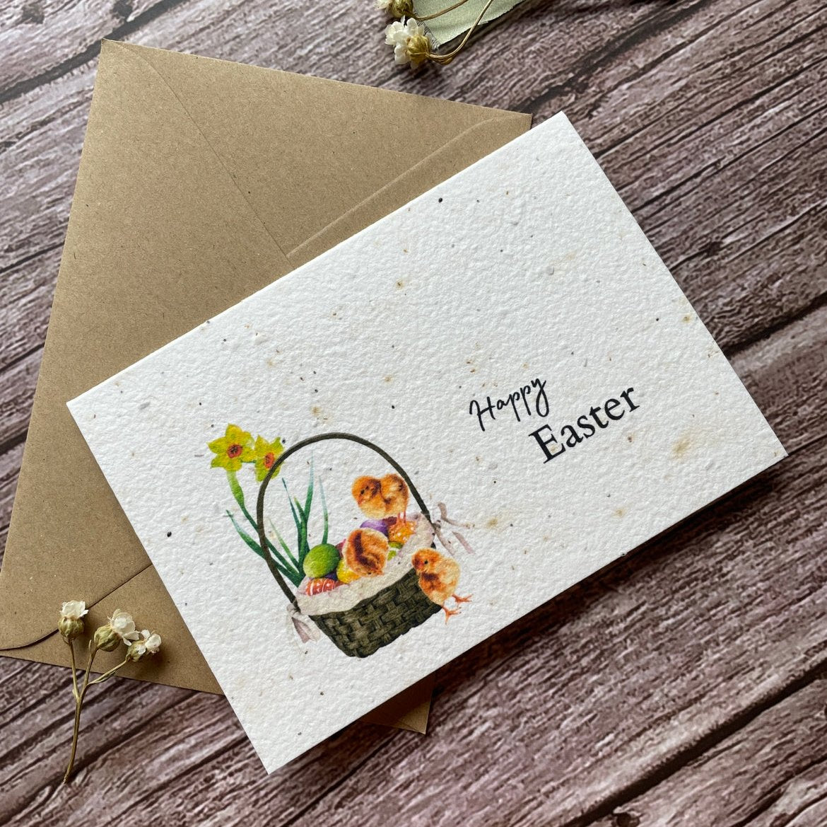 angled view of personalised plantable easter card with chicks and easter eggs, showing wildflower seed paper, alakartcreations