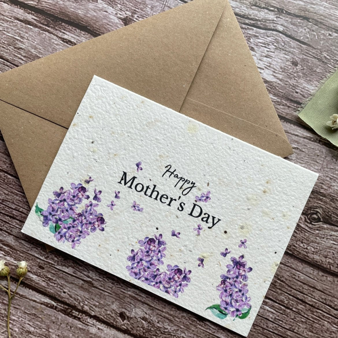 angled left view of personalised seed paper mother's day card featuring lilacs design and "Happy Mother’s Day" message alakartcreations