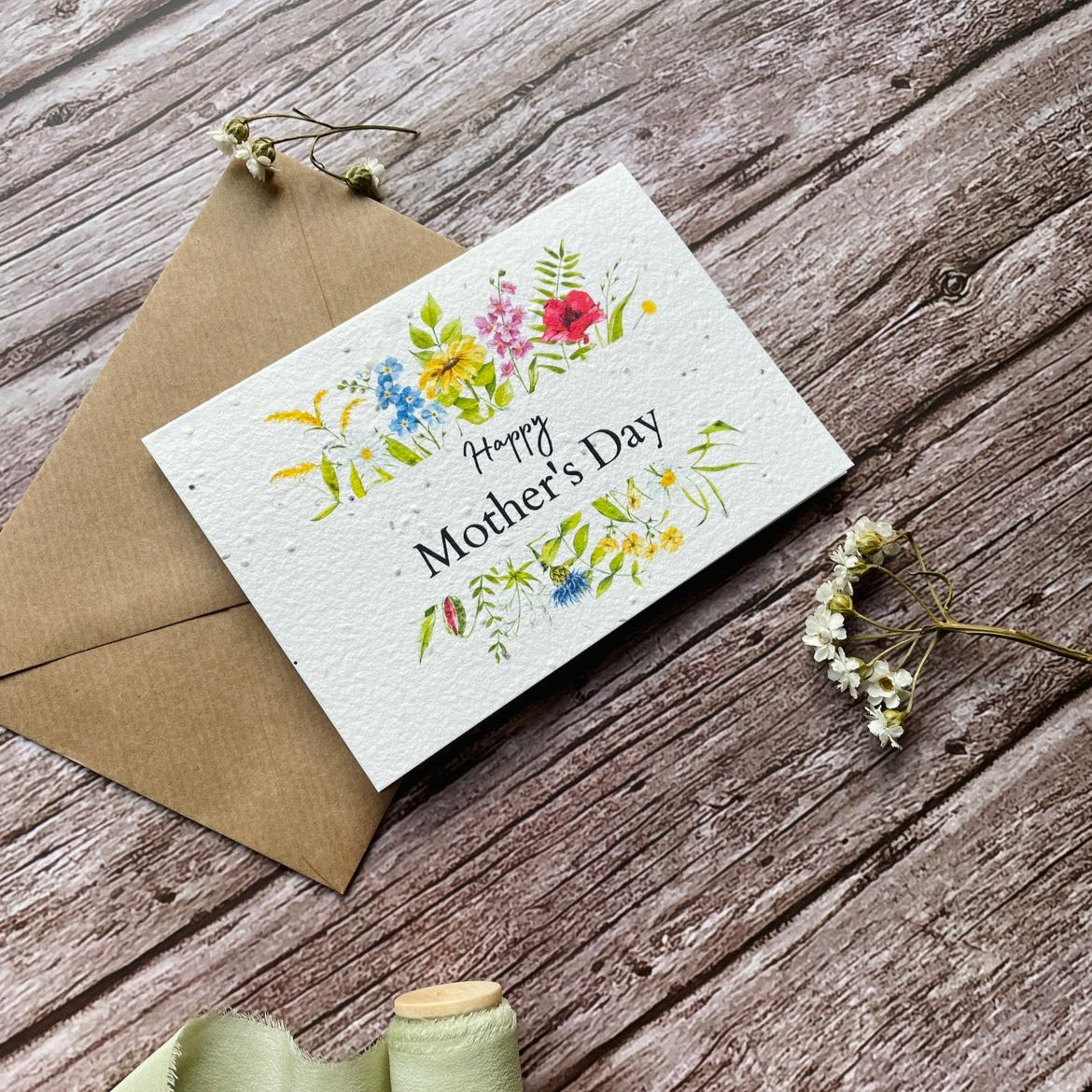 angled left view of personalised seed paper mother's day card featuring wildflower foliage border and "Happy Mother’s Day" message alakartcreations