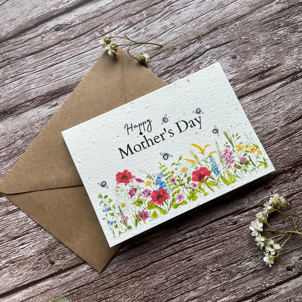 angled left view of personalised seed paper mother's day card featuring wildflower meadow illustration and "Happy Mother’s Day" message alakartcreations