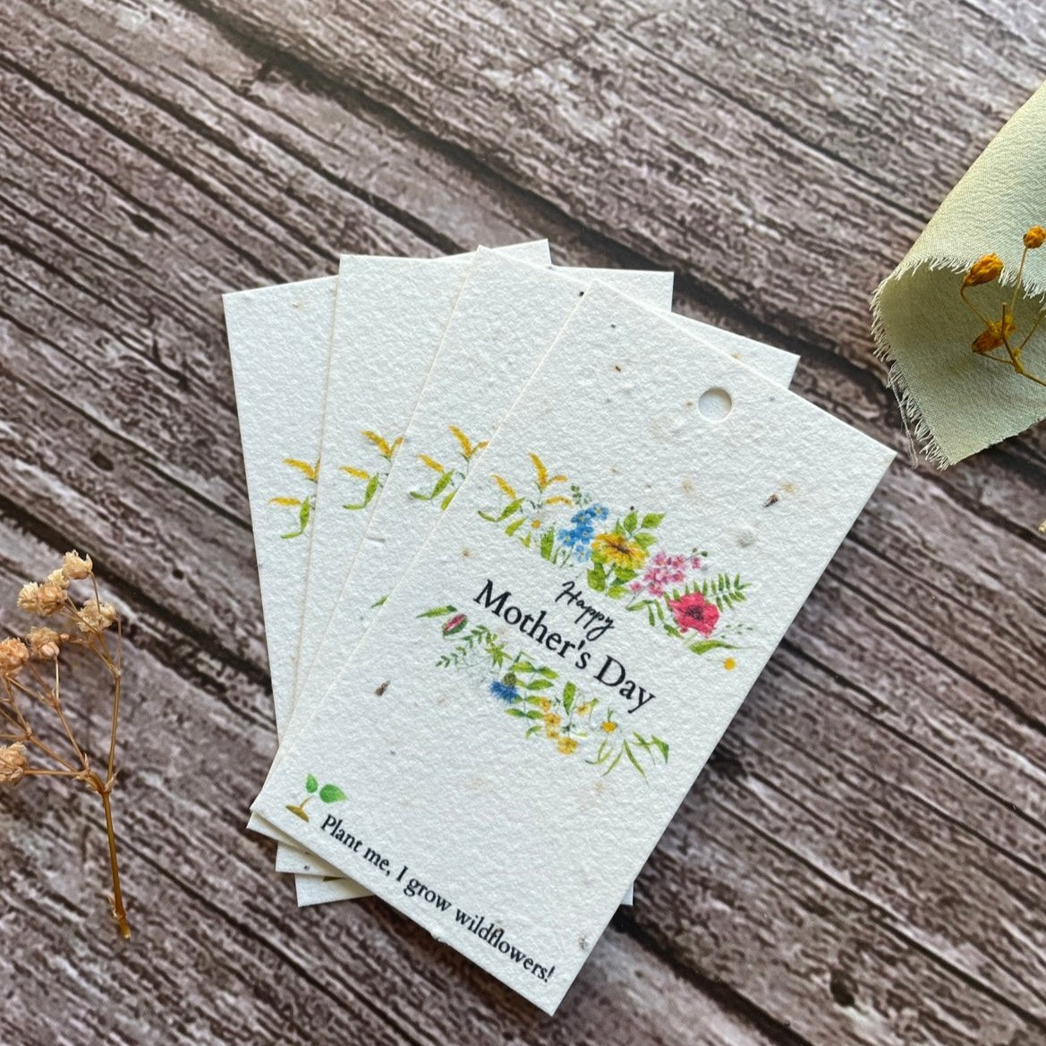 angled right view of plantable mother's day gift tag with wildflower foliage illustration and 'happy mother's day' wording alakartcreations
Back
