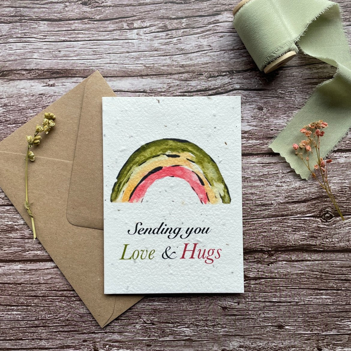 Front view of the Love & Hugs Rainbow Personalised Plantable Card featuring a colourful rainbow design.