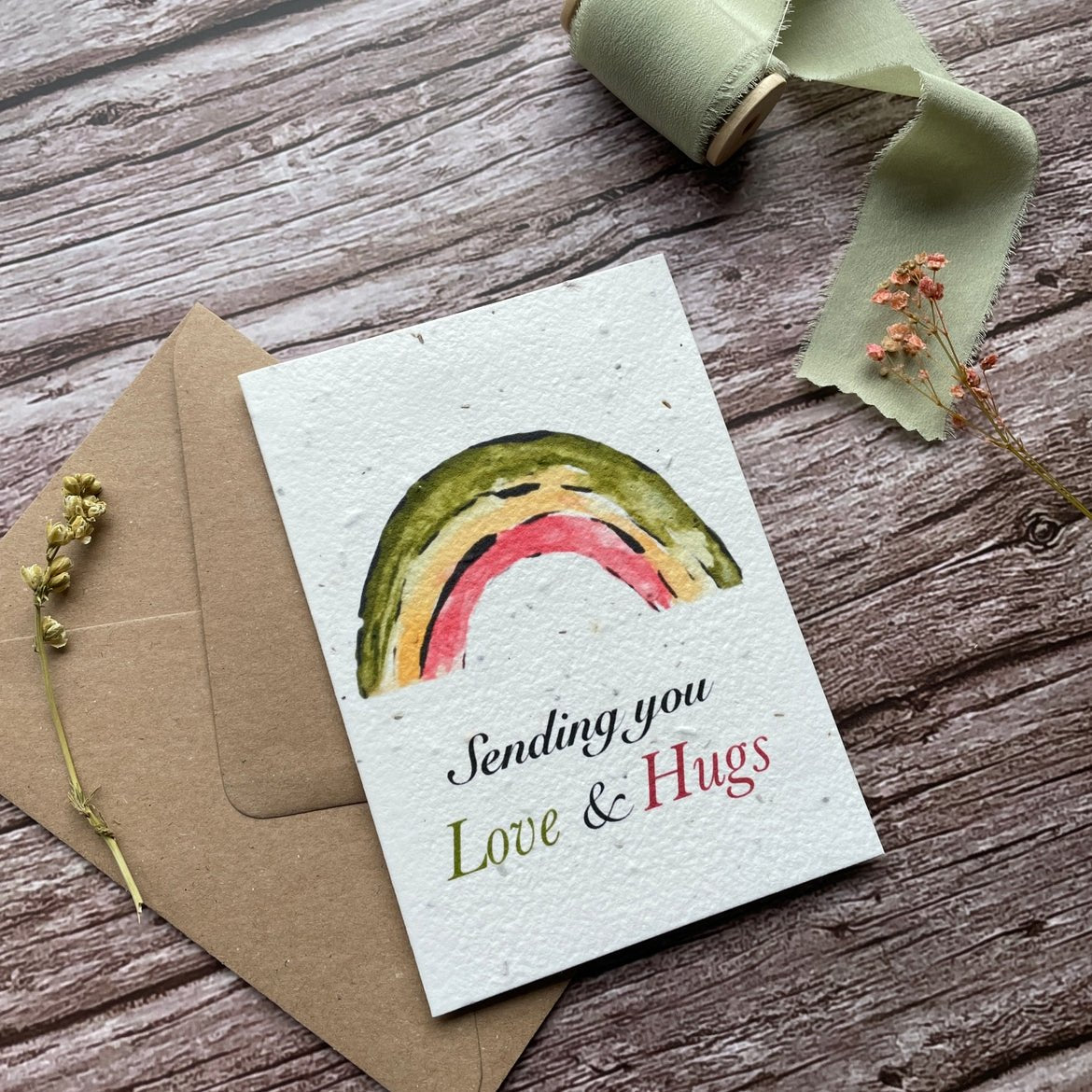 Angled left view of the Love &amp; Hugs Rainbow Personalised Plantable Card highlighting the cheerful design.