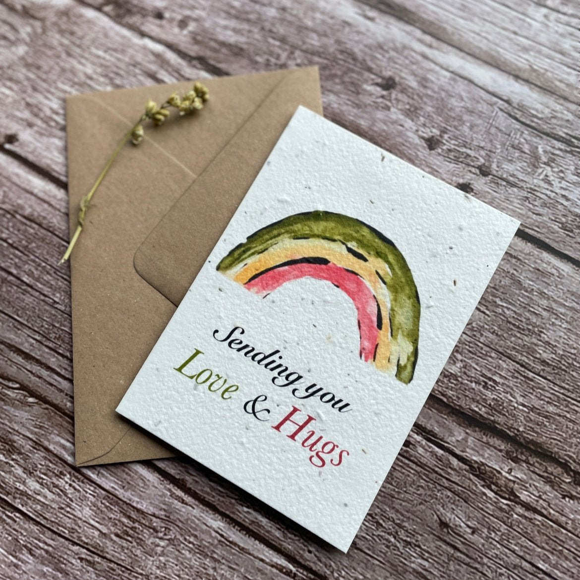 Angled right view of the Love & Hugs Rainbow Personalised Plantable Card showcasing the vibrant rainbow motif.