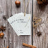 Group of five minimalistic christmas tree plantable gift tags featuring optional green twine.