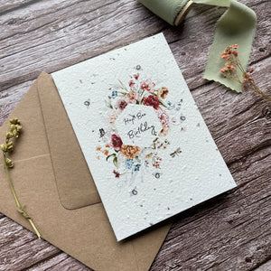 angled view of personalised buzzing bees plantable card featuring 'hap-bee birthday' text and floral border