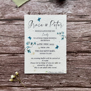 plantable evening guest wedding invitations in dusty blue theme, showing front view, floral design on wooden background, eco-friendly