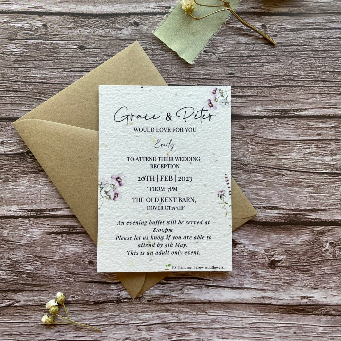 plantable evening guest wedding invitations in lilac theme, front view with eco-friendly brown kraft envelope, floral design on wooden background