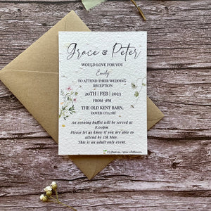 plantable evening guest wedding invitations spring green theme, front view with eco-friendly brown kraft envelope, floral design on wooden background