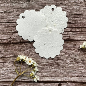 seed paper flower shaped tags on wooden surface