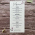 plantable seed paper wedding menu card in lilac theme, showing a close-up front view, floral design on wooden background, eco-friendly