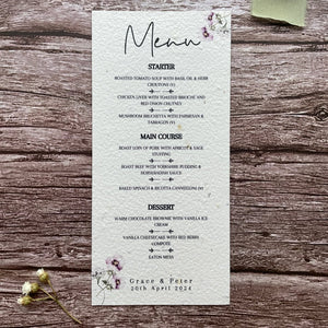 plantable seed paper wedding menu card in lilac theme, showing a close-up front view, floral design on wooden background, eco-friendly