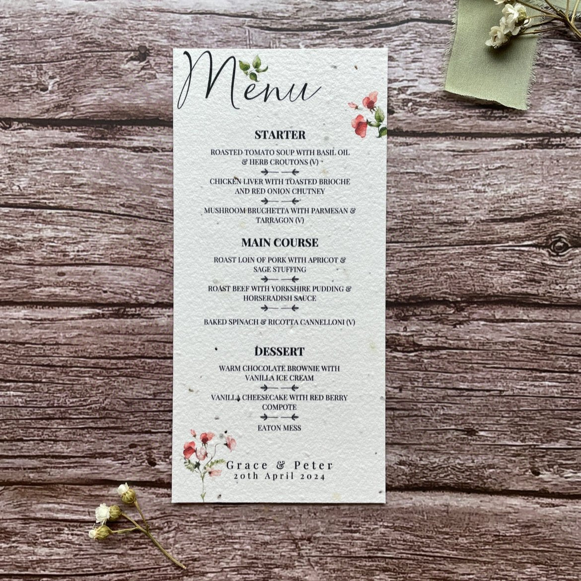 plantable seed paper wedding menu card in sweet pea theme, showing a close-up front view, floral design on wooden background, eco-friendly