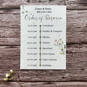 plantable seed paper wedding order of service card in spring green theme, showing front view, floral design on wooden background, eco-friendly