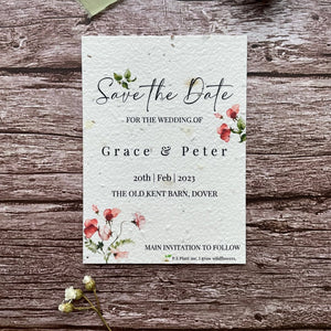 plantable seed paper wedding save the date card in sweet pea theme, showing front close-up view, floral design on wooden background, eco-friendly