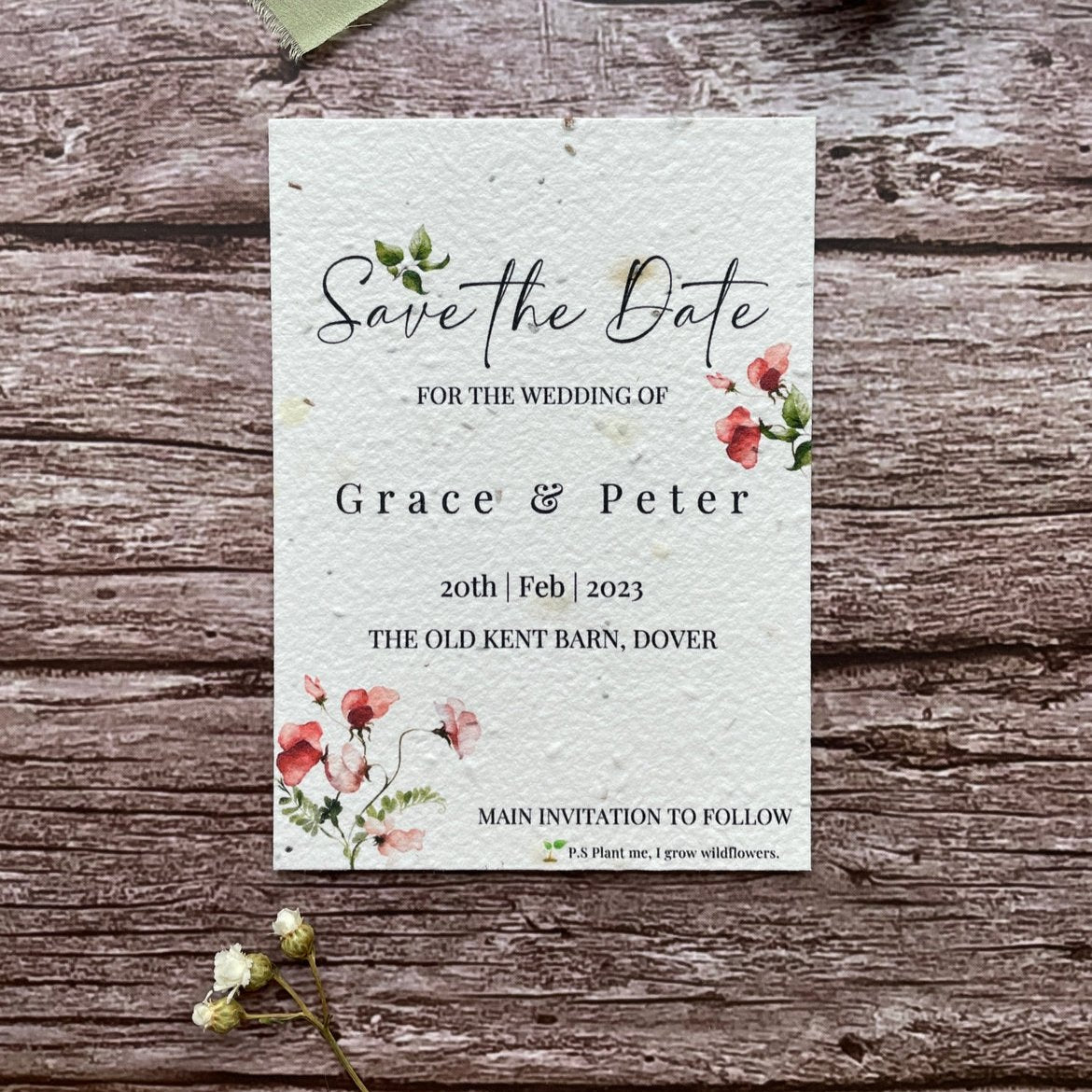 plantable seed paper wedding save the date cards in sweet pea theme, front close-up view with floral design on wooden background, eco-friendly, alakartcreations