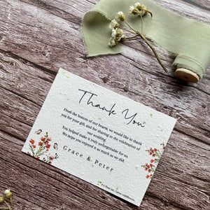 plantable seed paper wedding thank you cards in burnt orange theme, showing angled view, floral design on wooden background, eco-friendly