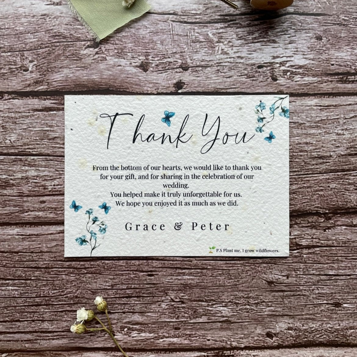 plantable seed paper wedding thank you cards in dusty blue theme, showing front view, floral design on wooden background, eco-friendly