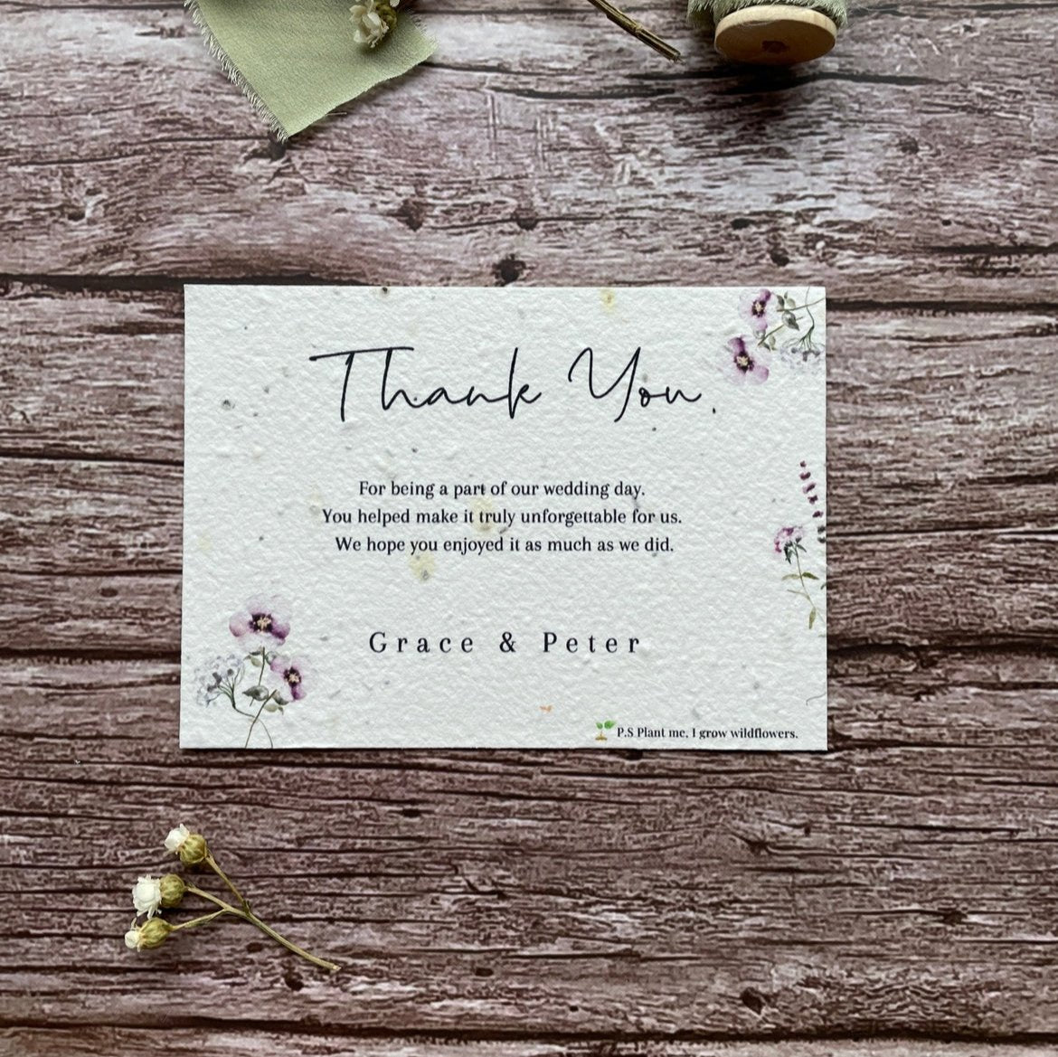 plantable seed paper wedding thank you cards in lilac theme, showing front view, floral design on wooden background, eco-friendly