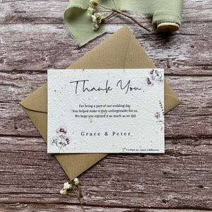 plantable seed paper wedding thank you cards in lilac theme, showing front view with eco-friendly brown kraft envelope, floral design on wooden background