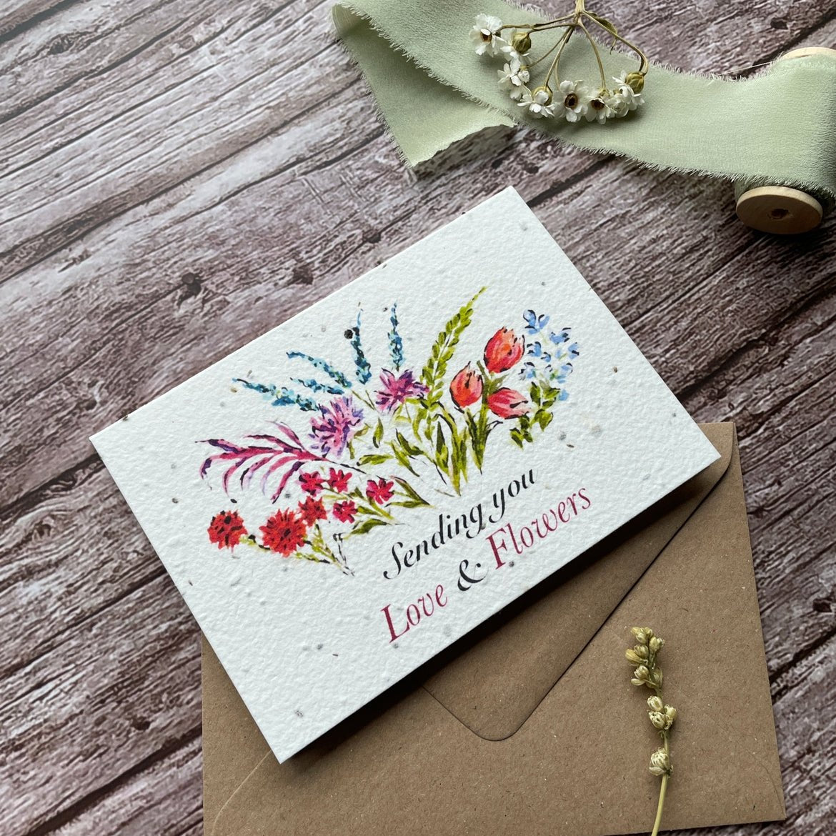 Right-angled view of the 'Sending Love and Flowers' plantable card showcasing the vibrant floral design. Made from eco-friendly seed paper by A La KArt Creations.